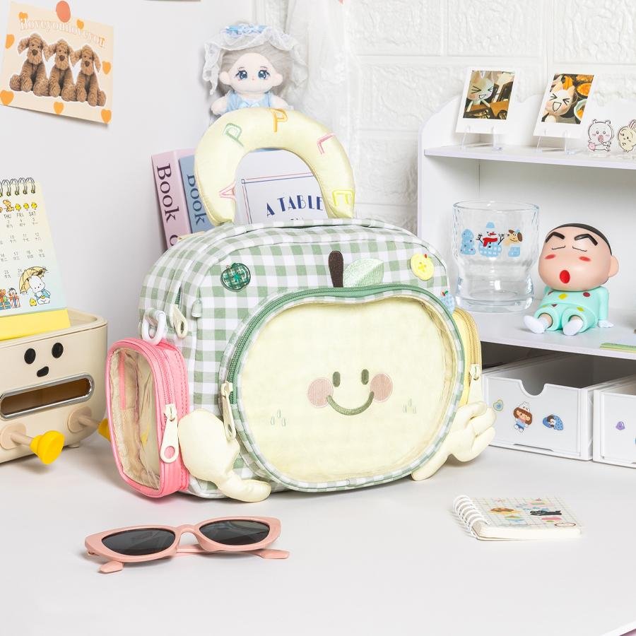 A person wearing a custom Ita Bag Backpack, displaying various fandom pins in the clear window.